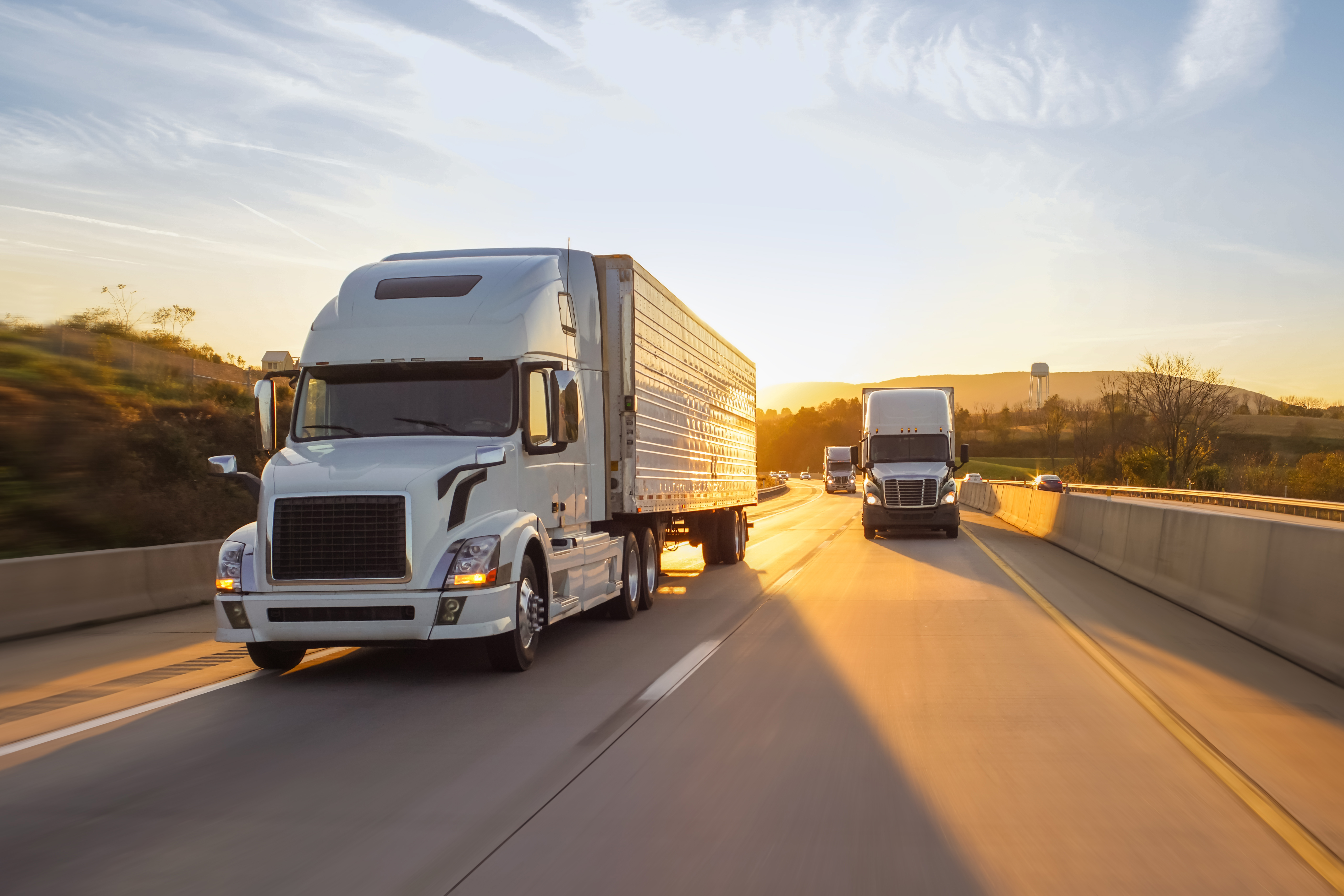 three-trucks-highway-sunrise